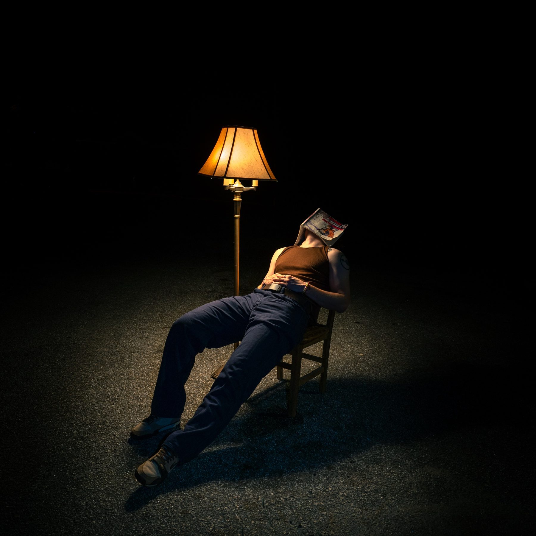 Late Noper leaning back in a chair with a comic book covering his face