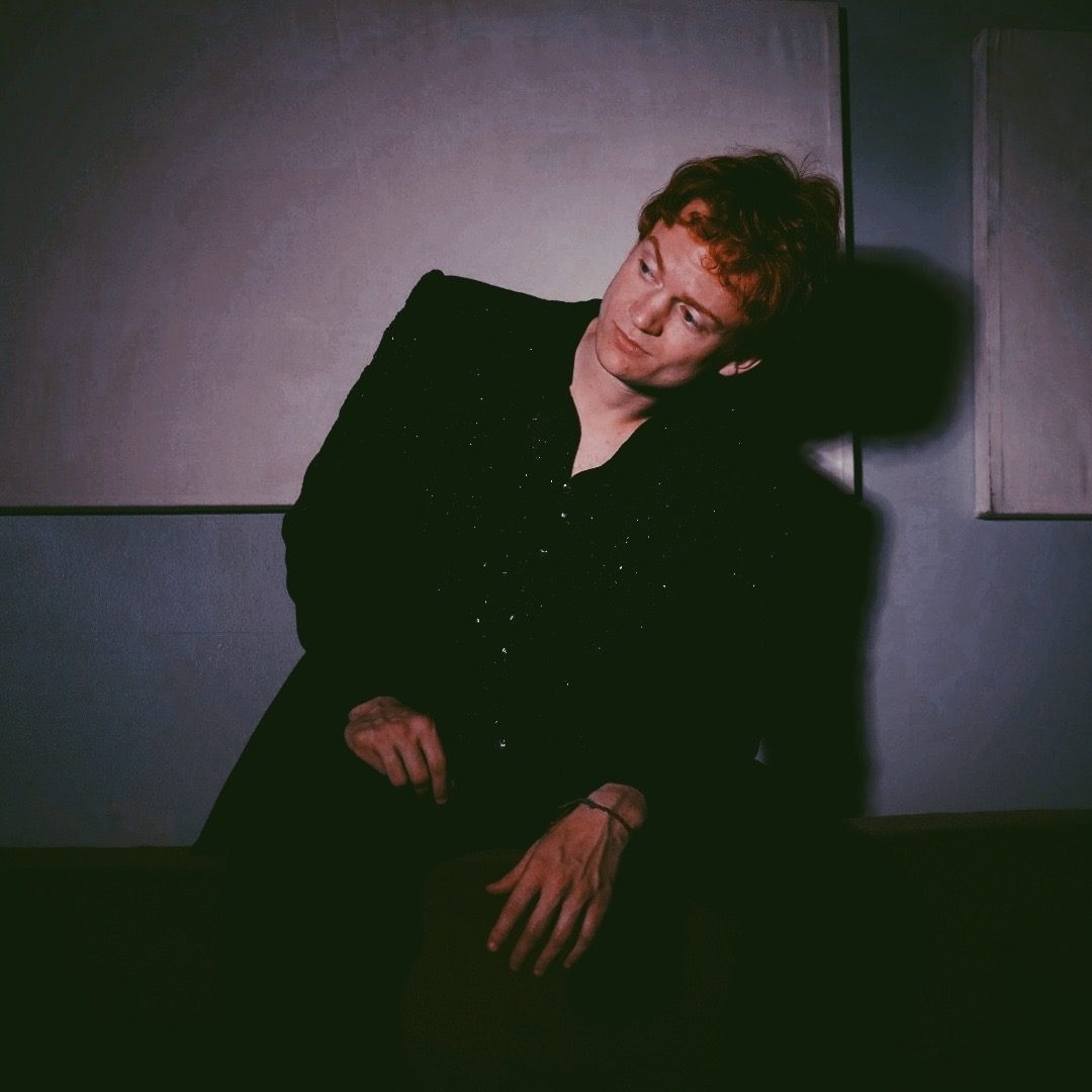 Portrait of Late Noper in a dark sequined shirt