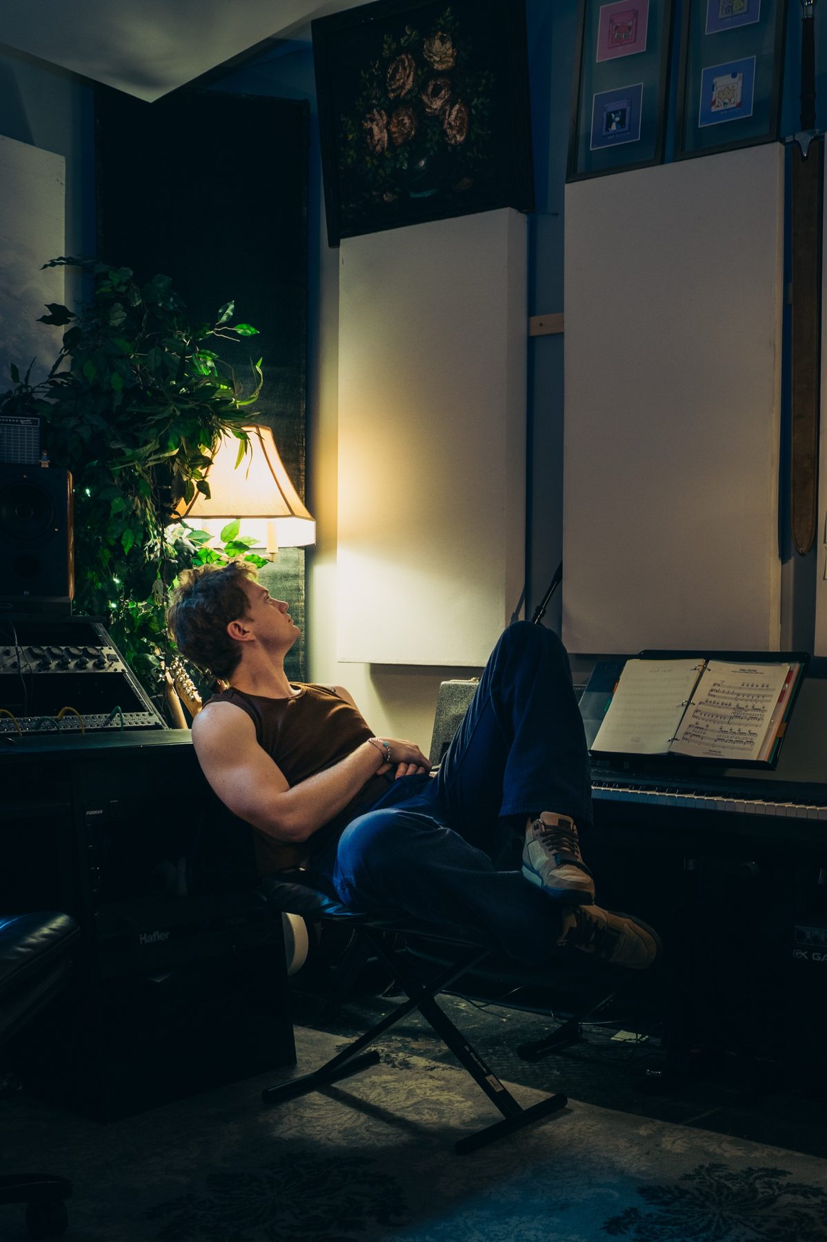 Late Noper relaxing in a home studio surrounded by plants and gear